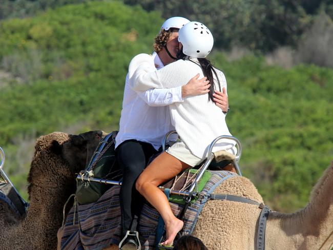 They even managed to share a kiss while the camel strolled down Lighthouse Beach. Picture: Nathan Edwards