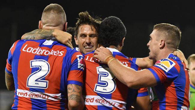 Mitchell Pearce celebrates a try with his Knights teammates.