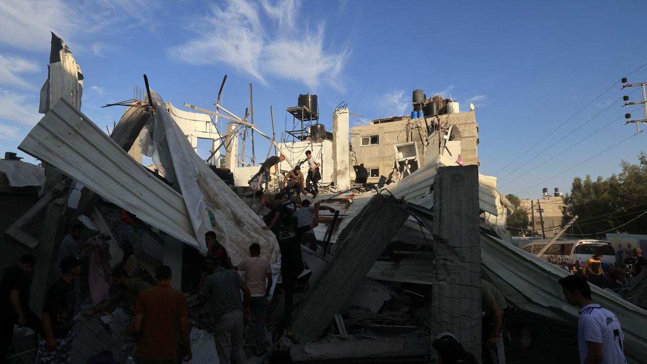 Palestinians inspect the debris after an Israeli strike near a United Nations Relief and Works Agency for Palestine Refugees school in Khan Yunis. Picture: Mahmud HAMS / AFP