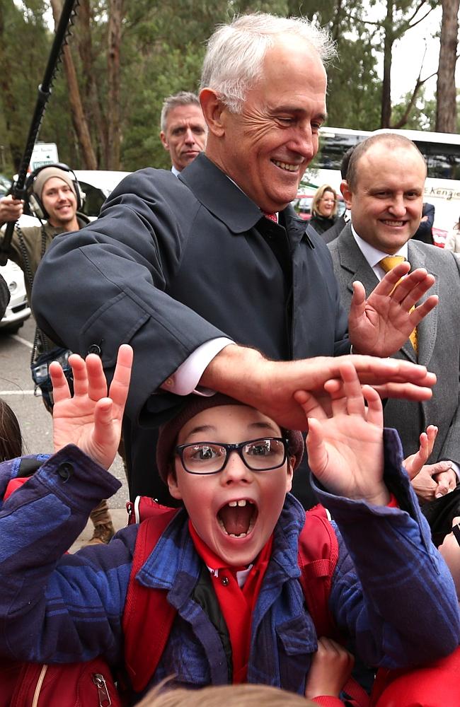 Turnbull’s high five with the kids misses the mark. Picture: Lyndon Mechielsen/News Corp