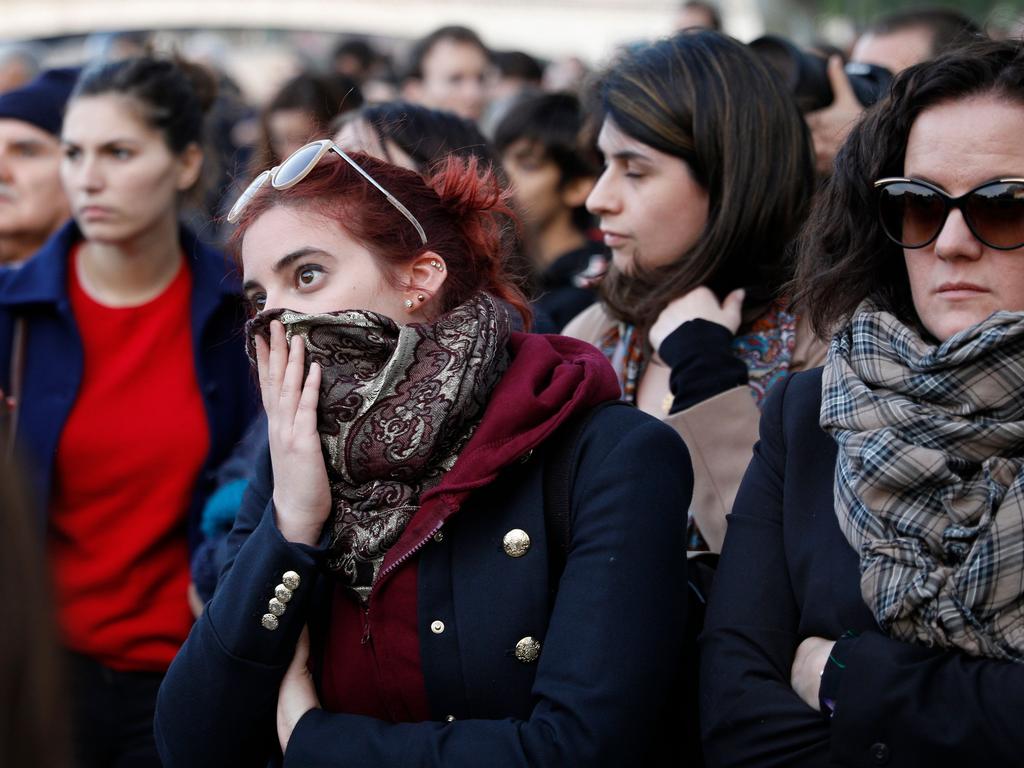 Stunned onlookers watch as the cathedral burns. Picture: AFP