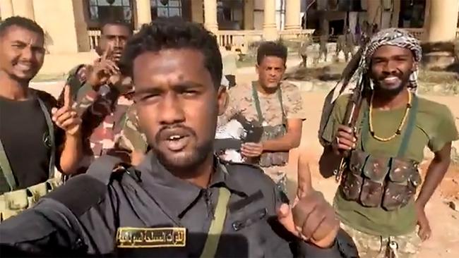 Sudanese soldiers celebrate after retaking the presidential palace in Khartoum in an image taken from a video. Picture: AFP