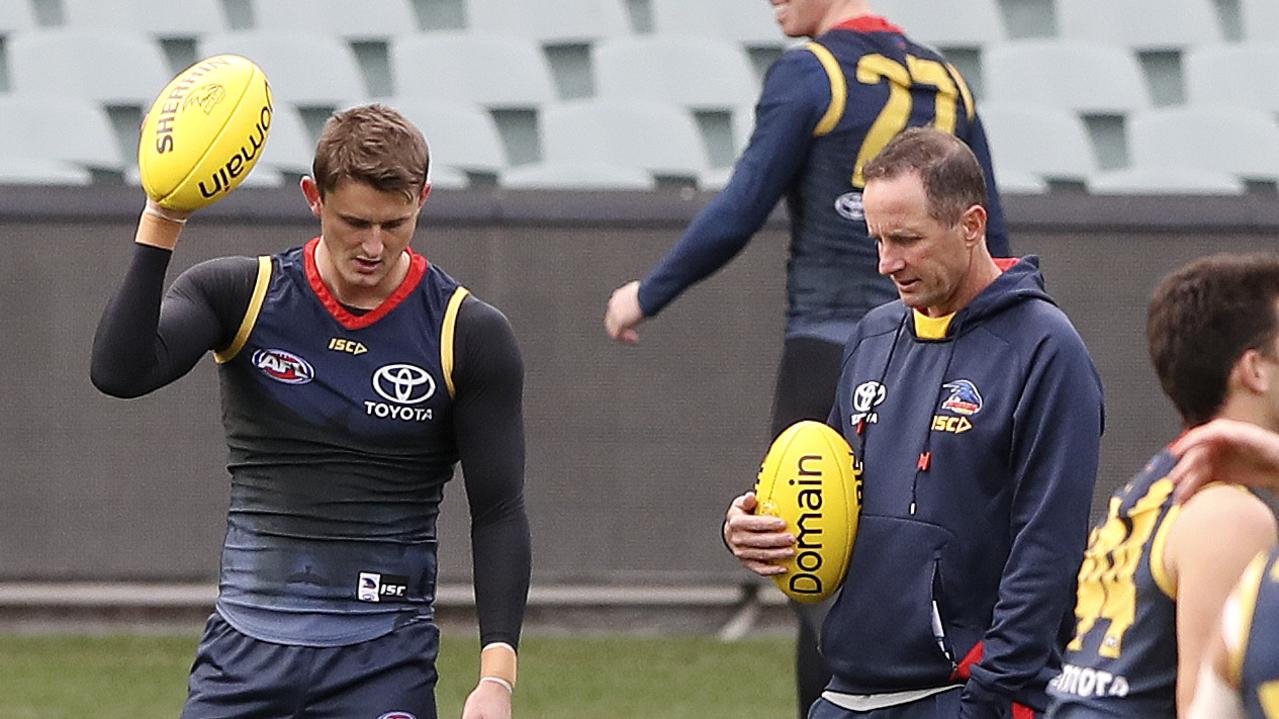 Adelaide’s Matt Crouch talks to his coach Don Pyke at the start of training on Thursday. Picture: Sarah Reed