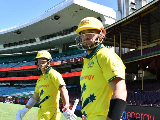 Australia's David Warner and Aaron Finch run out to an empty stadium during game 1 of the mens ODI between Australia and New Zealand at the SCG in Sydney, Friday, March 13, 2020. Cricket Australia decided to close all matches in the ODI series against New Zealand to spectators due to the COVID-19 Coronavirus. (AAP Image/Dean Lewins) NO ARCHIVING, EDITORIAL USE ONLY, IMAGES TO BE USED FOR NEWS REPORTING PURPOSES ONLY, NO COMMERCIAL USE WHATSOEVER, NO USE IN BOOKS WITHOUT PRIOR WRITTEN CONSENT FROM AAP