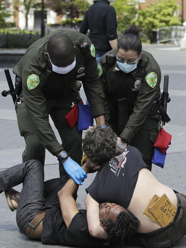 Park Police officers break up a fight in Washington Square Park, New York. Picture: AP