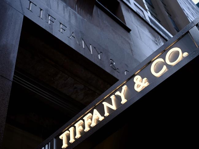 (FILES) In this file photo the logo of luxury jewelry and specialty retailer Tiffany & Co is seen on 5th Avenue in Manhattan on October 27, 2019  in New York City. - Shares of Tiffany were under pressure for a second straight session Wednesday following a report that its deal to be acquired by LVMH may be coming apart. Tiffany's stock was down 0.6 percent in mid-morning trading at $116.32 after shares dropped nine percent on June 3, 2020. Fashion publication Women's Wear Daily reported that the French luxury giant was reevaluating the $16.2 billion Tiffany acquisition previously seen as worthy investment to bolster the company's US presence. (Photo by Johannes EISELE / AFP)