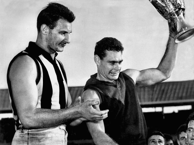 Barassi holding the 1964 premiership cup.