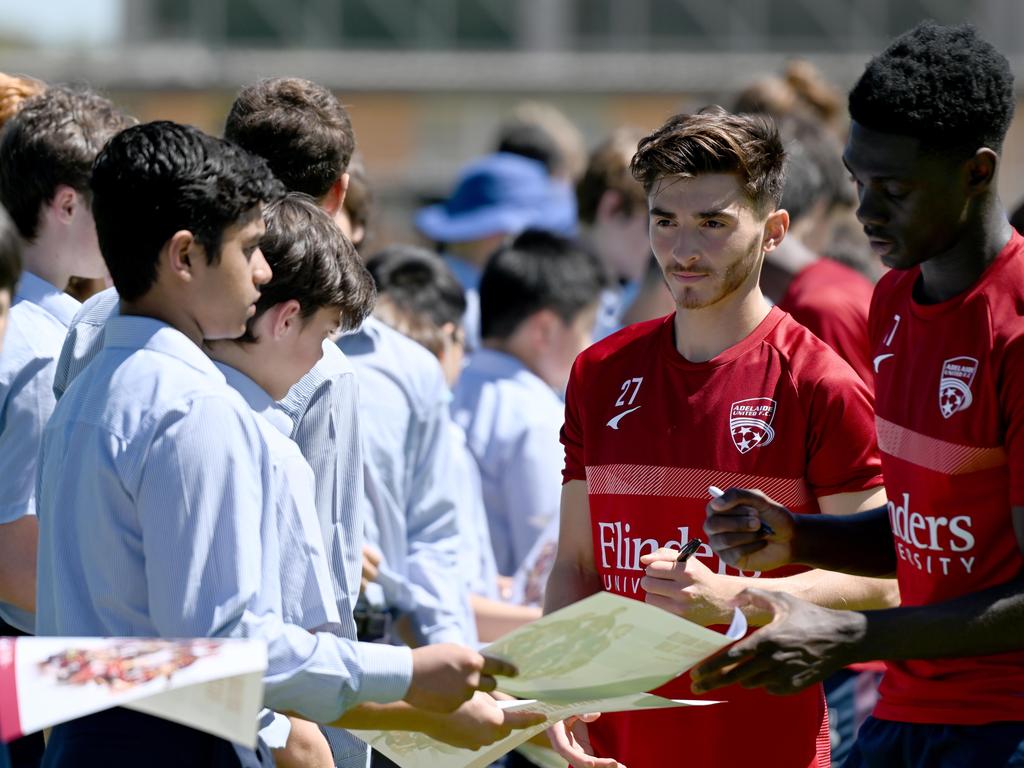 Josh Cavallo signs autographs after a Reds training session at St Peters College. Picture: Naomi Jellicoe