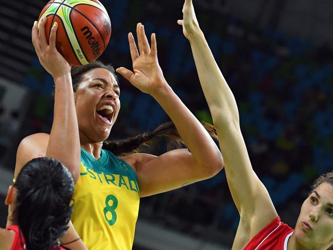 Australia's centre Elizabeth Cambage (2nd L) takes a shot between Serbia's shooting guard Ana Dabovic (L) and Serbia's centre Dragana Stankovic during a Women's quarterfinal basketball match between Australia and Serbia at the Carioca Arena 1 in Rio de Janeiro on August 16, 2016 during the Rio 2016 Olympic Games. / AFP PHOTO / Andrej ISAKOVIC