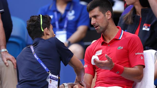 PERTH, AUSTRALIA - JANUARY 03: Novak Djokovic of Team Serbia receives treatment to his right arm during his singles match against Alex de Minaur of Team Australia during day six of the 2024 United Cup at RAC Arena on January 03, 2024 in Perth, Australia. (Photo by Paul Kane/Getty Images)