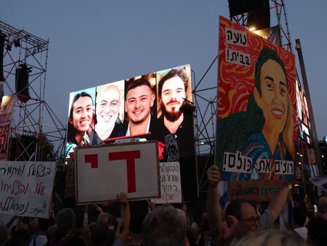 A billboard depicting from left: Noa Argamani, Shlomi Ziv, Almog Meir Jan and Andrey Kozlov, the four Israeli hostages rescued by the Israeli army is erected as Israeli activists rally during an anti-government demonstration. Picture: AFP