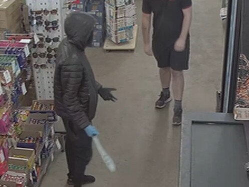 Abdirahman Basa, 20, clutching a machete at NQR supermarket Picture: Supplied.