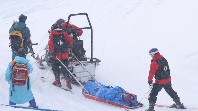 Belle Brockhoff of Team Australia is stretchered off the mountain after crashing during the Snowboard Mixed Team Cross Quarter Finals on Saturday in China. Picture: Cameron Spencer/Getty Images