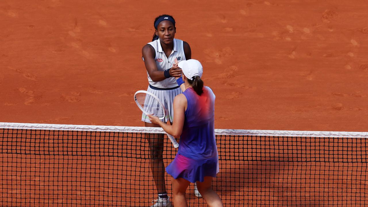 Iga Swiatek of Poland shakes hands with Coco Gauff of United States. Photo by Clive Brunskill/Getty Images.