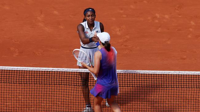 Iga Swiatek of Poland shakes hands with Coco Gauff of United States. Photo by Clive Brunskill/Getty Images.