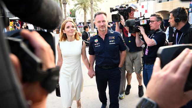 Christian Horner and Geri Horner walk in the Paddock holding hands. Photo by Clive Mason/Getty Images.