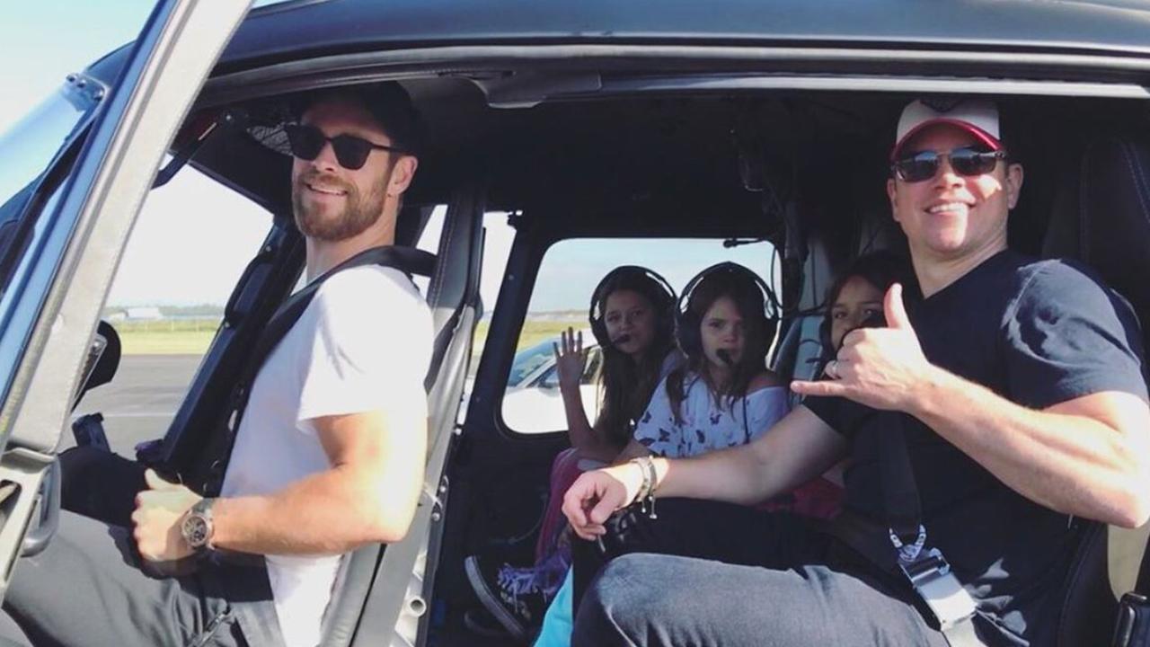 Chris Hemsworth with Matt Damon and his family catching a helicopter at Brisbane Airport.