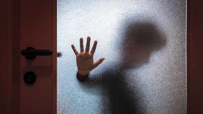 Blurred sad boy leaning open hand against glass door. TSS (The Southport School) stock photo. Photo: iStock