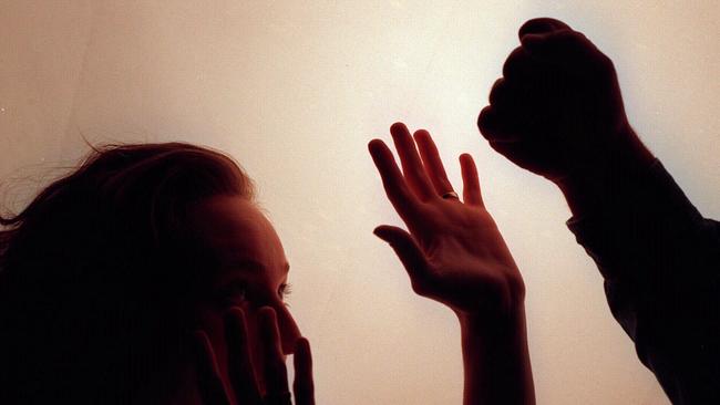 Domestic violence silhouette generic image - fist raised against woman./Violence