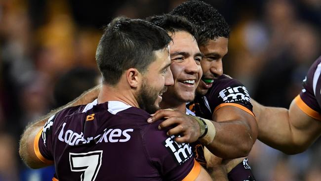 Kodi Nikorima of the Broncos celebrates scoring a try.