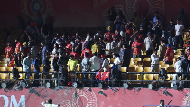 Spectators leave the stands after authorities evacuated the stadium during the 2025 IPL match between Punjab Kings and Delhi Capitals in Dharamsala, India. (Photo by Pankaj Nangia/Getty Images)