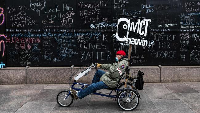 A man rides a tricycle near the courthouse during the trial of the former Minneapolis police officer charged with murdering George Floyd. Picture: Chandan Khanna/AFP