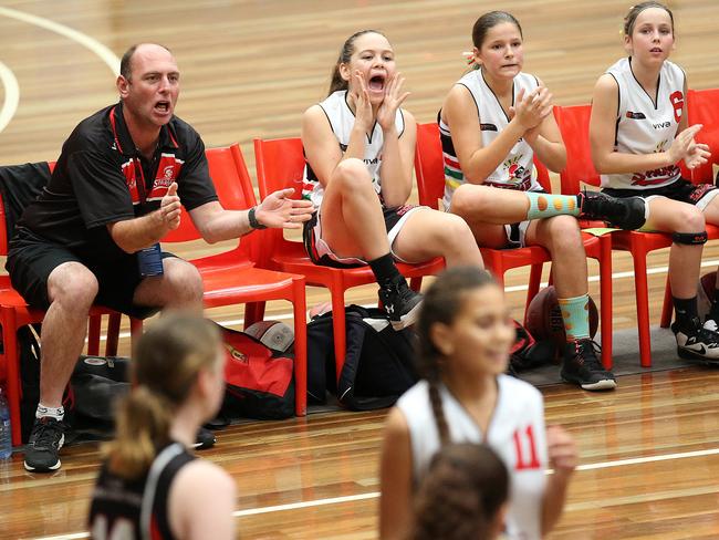 Spartans players cheer at the under 12 girls QBL basketball tournament in Brisbane during a game in 2019. It could be moments like these which could be missed by parents and grandparents under new government guidelines for community sport during COVID-19. Picture: Jono Searle/AAP