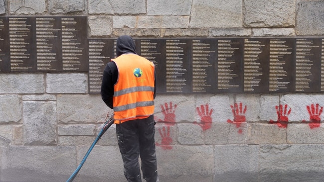 A city worker cleans graffiti off the Wall of the Righteous at the Holocaust memorial in Paris. Picture:AFP/Getty Images