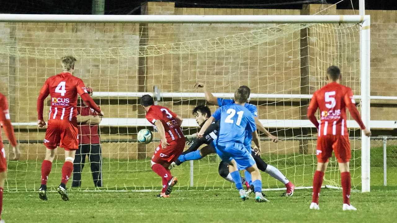 OPENING GOAL: South West Queensland Thunder striker Travis Cooper (obscured) scores against Olympic FC at Toowoomba's Clive Berghofer Stadium. Picture: Nev Madsen