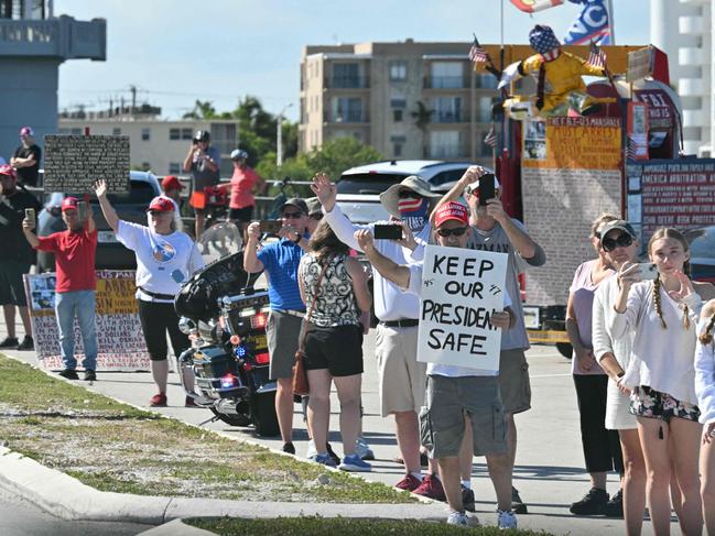 Supporters of US President Donald Trump cheer as he travels to Palm Beach International Airport in West Palm Beach, Florida. Picture: AFP