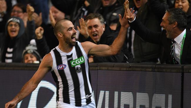 Steele Sidebottom celebrates a goal with a fan.