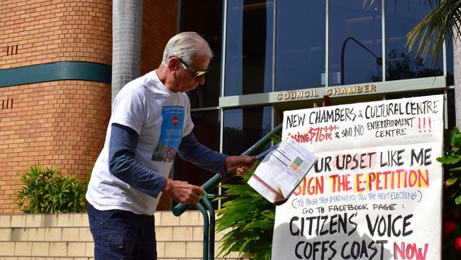 George Partos burning his rates notice outside Coffs Harbour City Council chambers in protest against the planned Cultural and Civic Space.