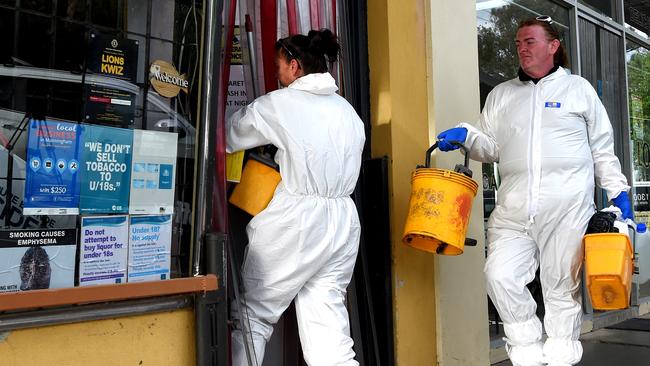 Crime scene cleaners arrive at a store where a man was shot dead. Picture: Nicole Garmston