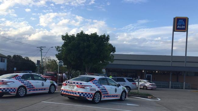 Police at Aldi Booval where a man has fired arrows using a compound bow.