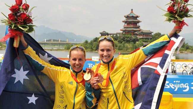 Beijing Olympics 2008 – triathlon gold medal winner triathlete athlete Emma Snowsill (l) and compatriot and bronze medallist Emma Moffatt, with their medals on the shore of the Ming Tomb Reservoir after competing in the women's triathlon at the 2008 Beijing Olympic Games in Beijing, 18 Aug 2008.