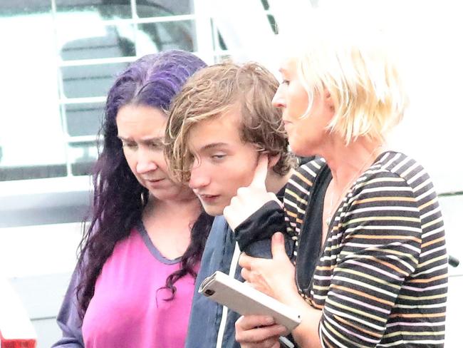 SYDNEY, AUSTRALIA - NewsWire Photos JANUARY 28, 2021:  Missing teen Leif Courtney pictured with his mum Leonie Morris (purple hair) just after being found. Missing teen Leif Courtney, aged 13 has been found by the water in a house boat by the Mooney Mooney wharf.Picture: NCA NewsWire / Damian Shaw