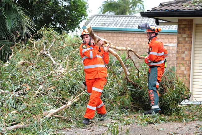 SES hard at work cleaning up the mess in Little Mountain following ferocious storm on Saturday. Picture: John Gass