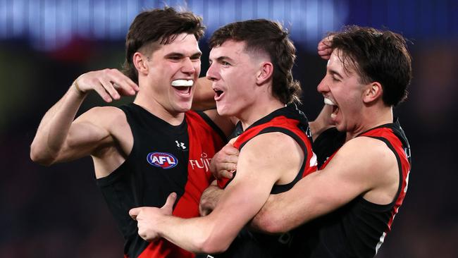 Archie Roberts celebrates with Bombers teammates Sam Durham and Nick Martin after kicking his first AFL goal. Picture: Mark Stewart