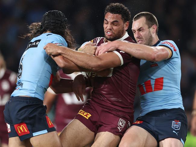 Storm’s Xavier Coates in action for the Maroons, trying to break through a tackle by Jarome Luai and Isaah Yeo of the Blues during game one of the 2024 Men's State of Origin series. Picture: Matt King/Getty Images