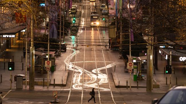 A lone pedestrian crosses the road on August 06, 2020 during Melbourne’s stage four lockdown. Picture: Getty Images