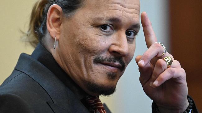(FILES) In this file photo taken on May 3, 2022 US actor Johnny Depp looks on during a hearing at the Fairfax County Circuit Courthouse in Fairfax, Virginia. - A US jury found June 1, 2022 that actress Amber Heard had made defamatory claims of abuse against her ex-husband Johnny Depp, and awarded him $15 million in damages. (Photo by JIM WATSON / POOL / AFP)