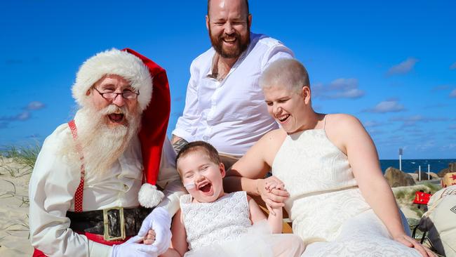 Paige Skarratts with parents Jake and Tania and Santa. Photo: Naturally Creative Photography