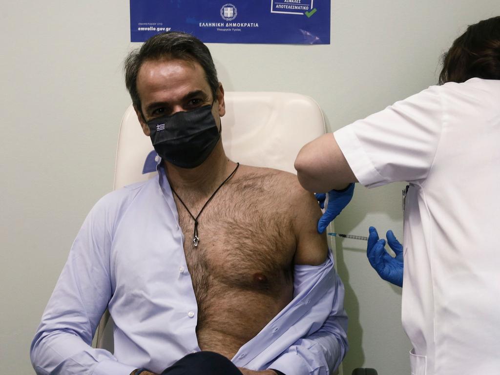 Clearly he needed to undo his shirt because it’s hard to roll up a sleeve over those bulging muscles. Picture: Yannis Kolesidis/AFP