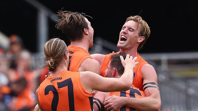 Lachie Keeffe is mobbed after booting one of his three goals. Picture. Phil Hillyard