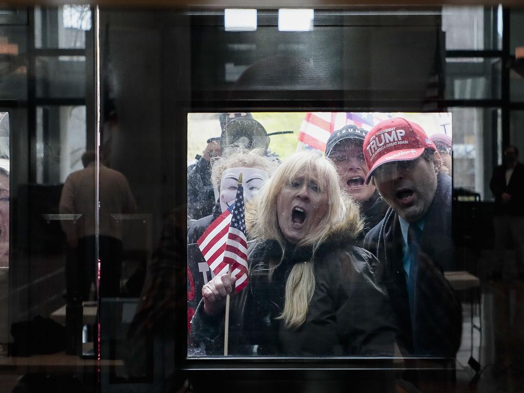 About 100 protesters assembled outside the building during Gov. Mike DeWine's weekday update on the state's response to the COVID-19 pandemic. Picture: Joshua A. Bickel/The Columbus Dispatch via AP