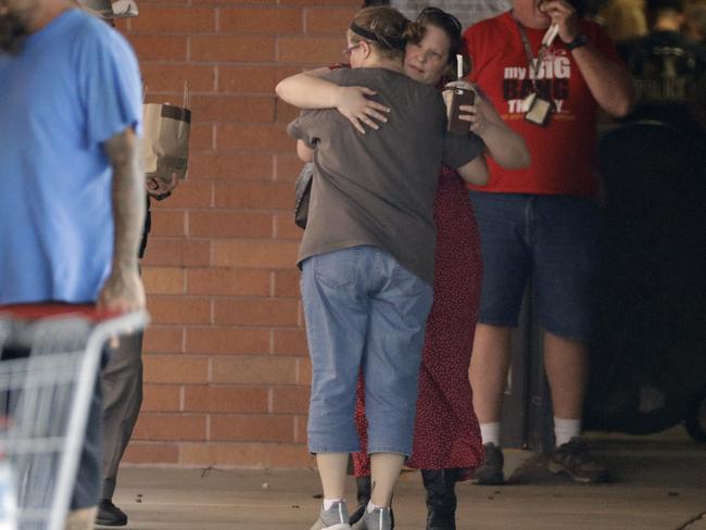 Locals embrace outside the unification centre at the Alamo Gym following the shooting. Picture: AP Photo/David J. Phillip