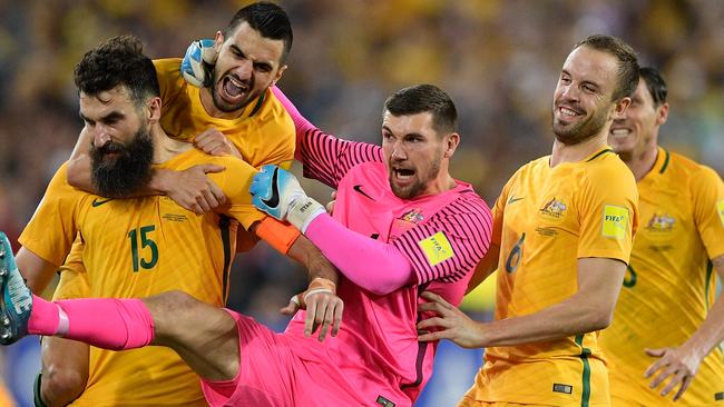 Teammates swarm Mile Jedinak after his second goal.