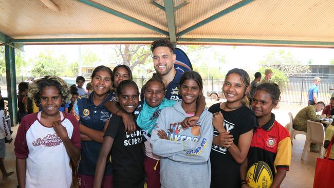 Mornington Island locals take photos with former North Queensland Cowboys star Antonio Winterstein. Picture: Peter Carruthers