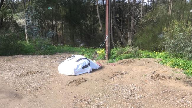 The bag of asbestos tied to a Stobie pole with the wetlands just metres away in the background. Picture: Supplied