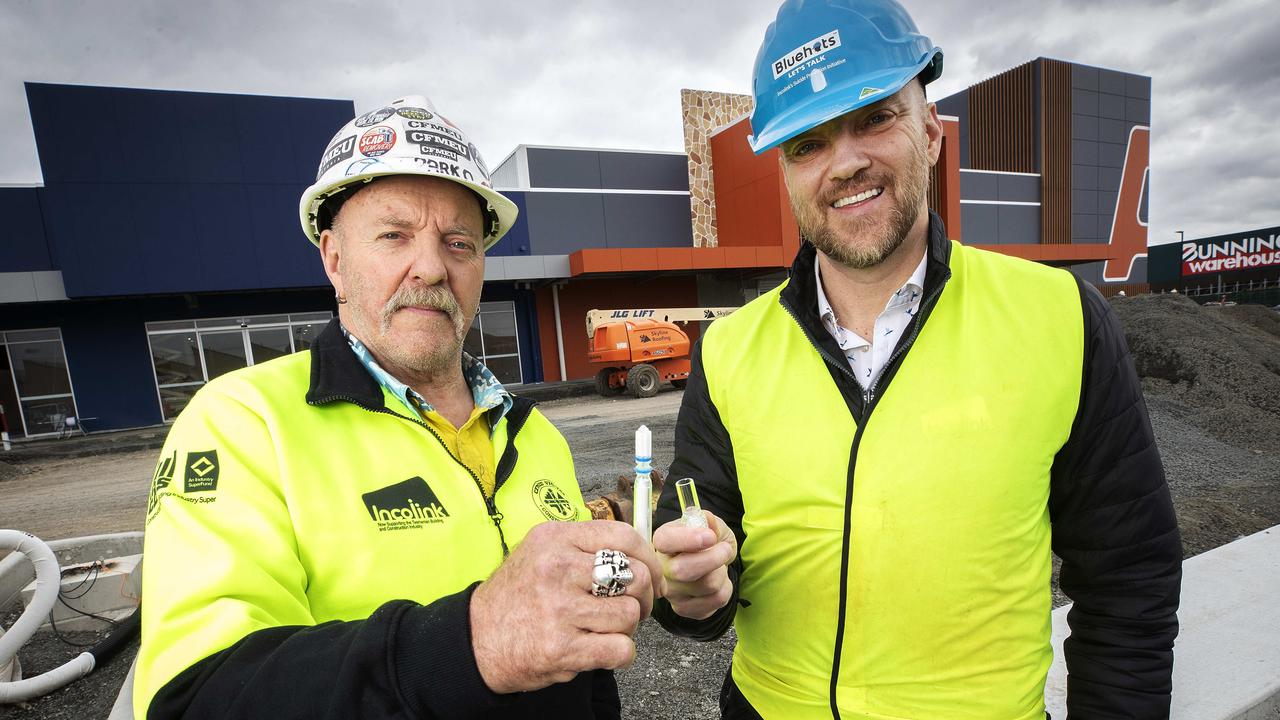 Hutchinson Builders health and safety representative Steve Parkinson and Incolink CEO Erik Locke with the rapid antigen test at Glenorchy. Picture: Chris Kidd.